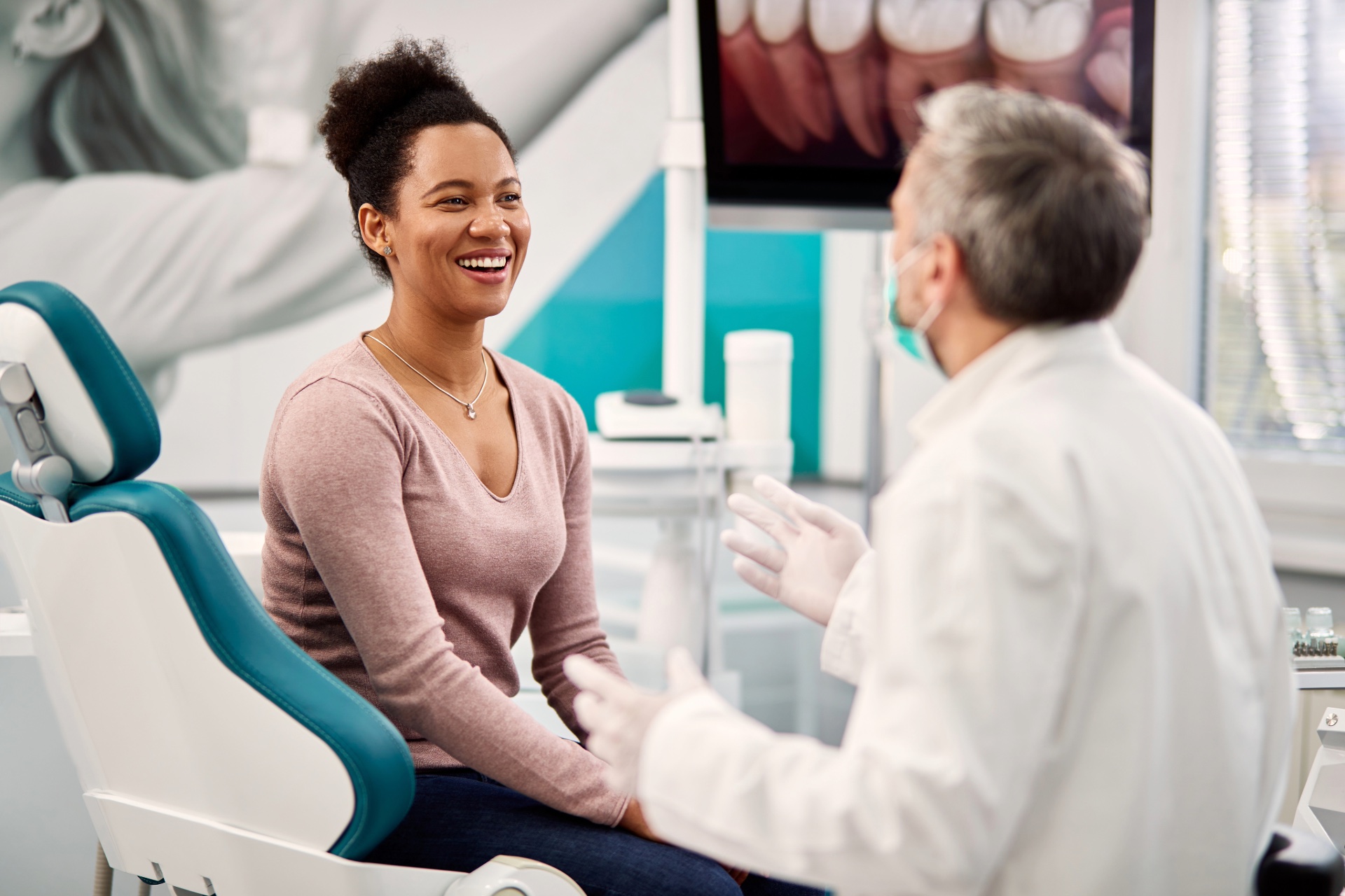 Smiling woman talking with her dentist