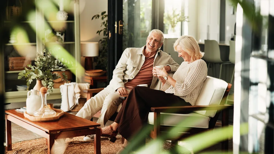 Couple relaxing together with coffee at home