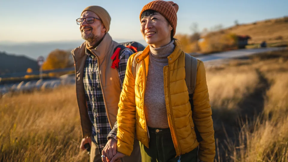 Active couple walking outdoors in warm evening light