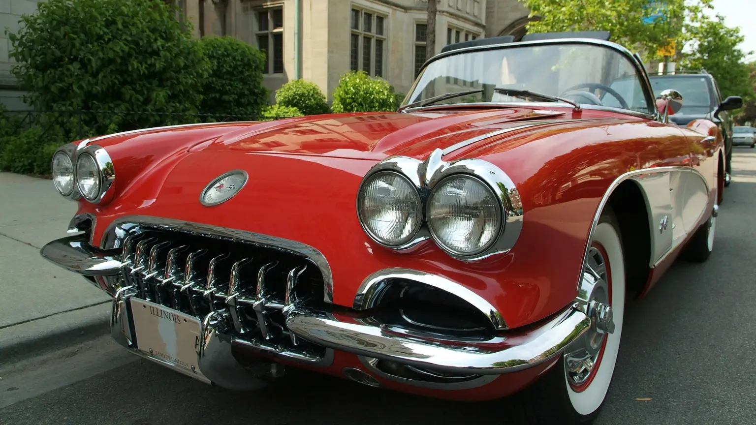 Red vintage convertible parked on a city street