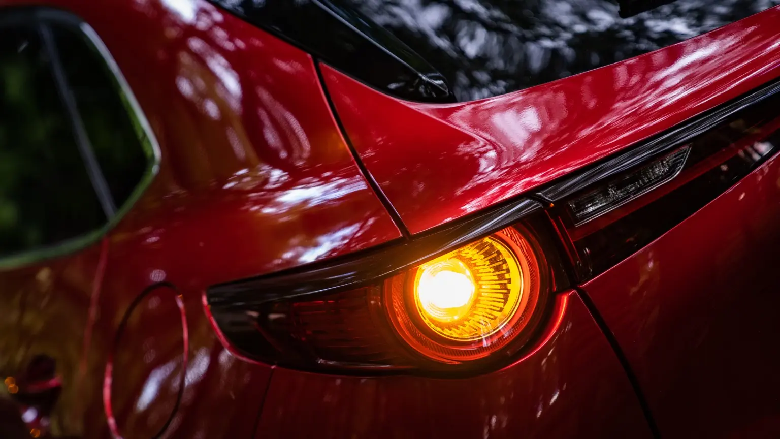 Red sports car taillight and rear body detail