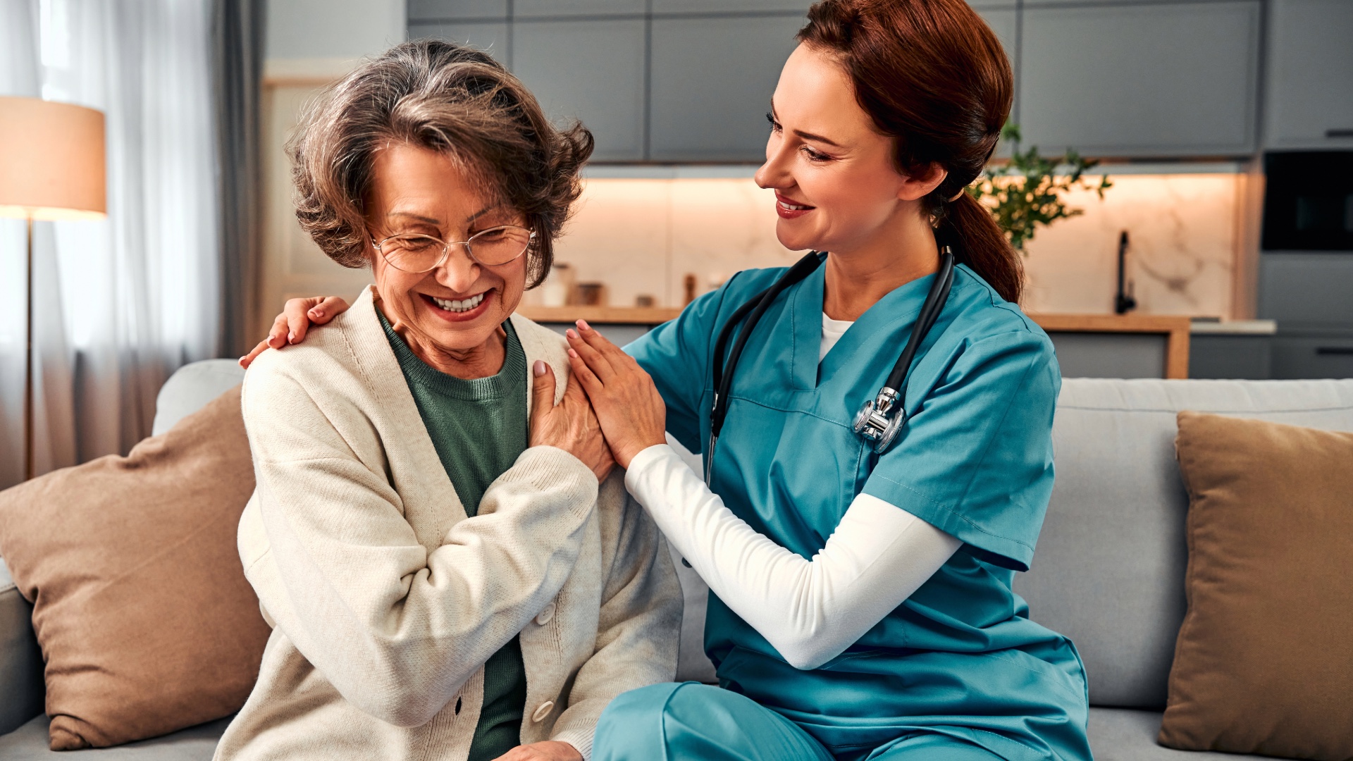 Home health care nurse supporting an older woman at home