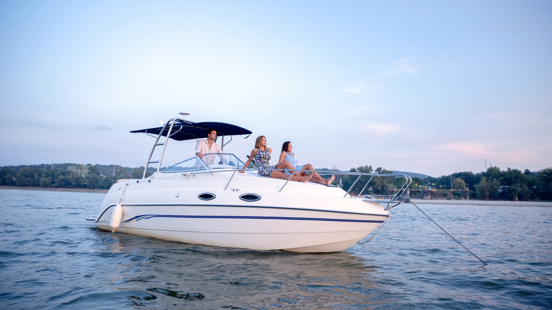 Family and friends relaxing on a white motorboat