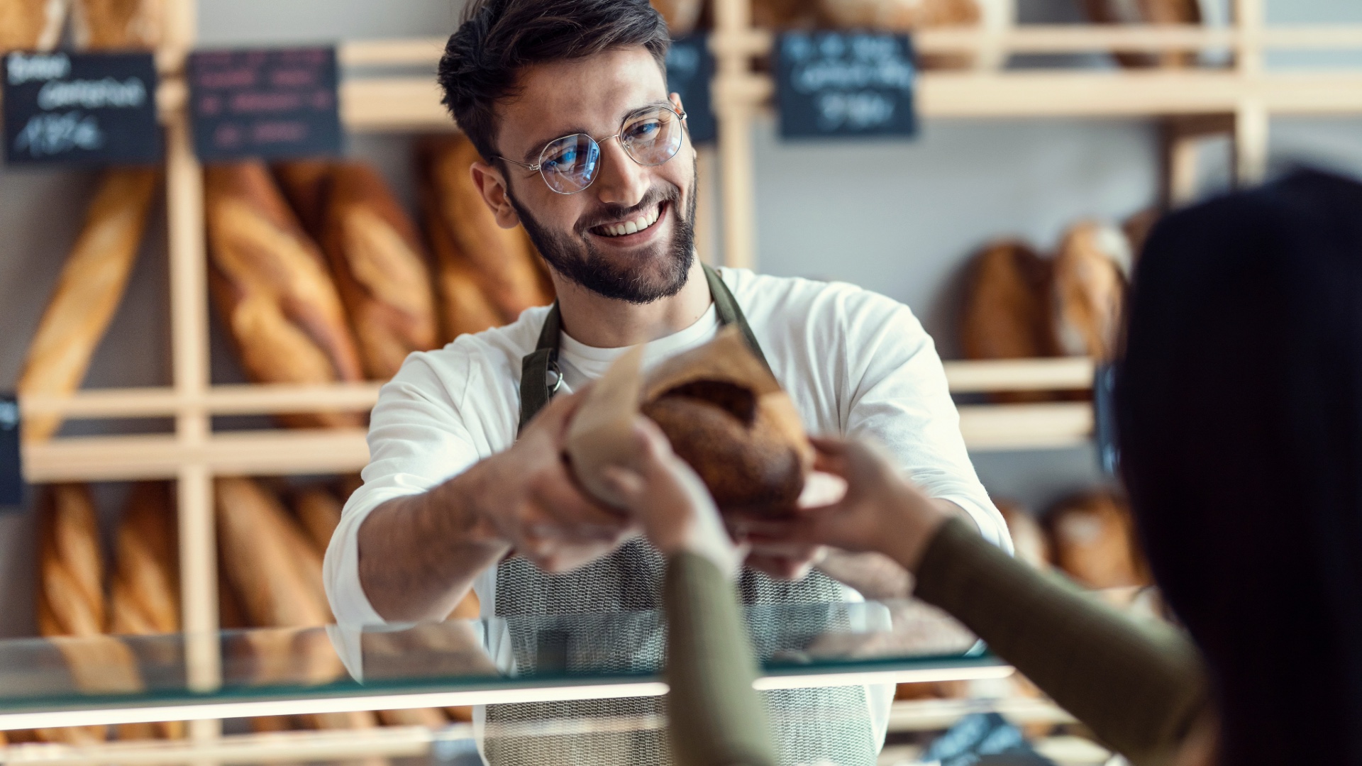 Bakery owner helping a customer at the counter