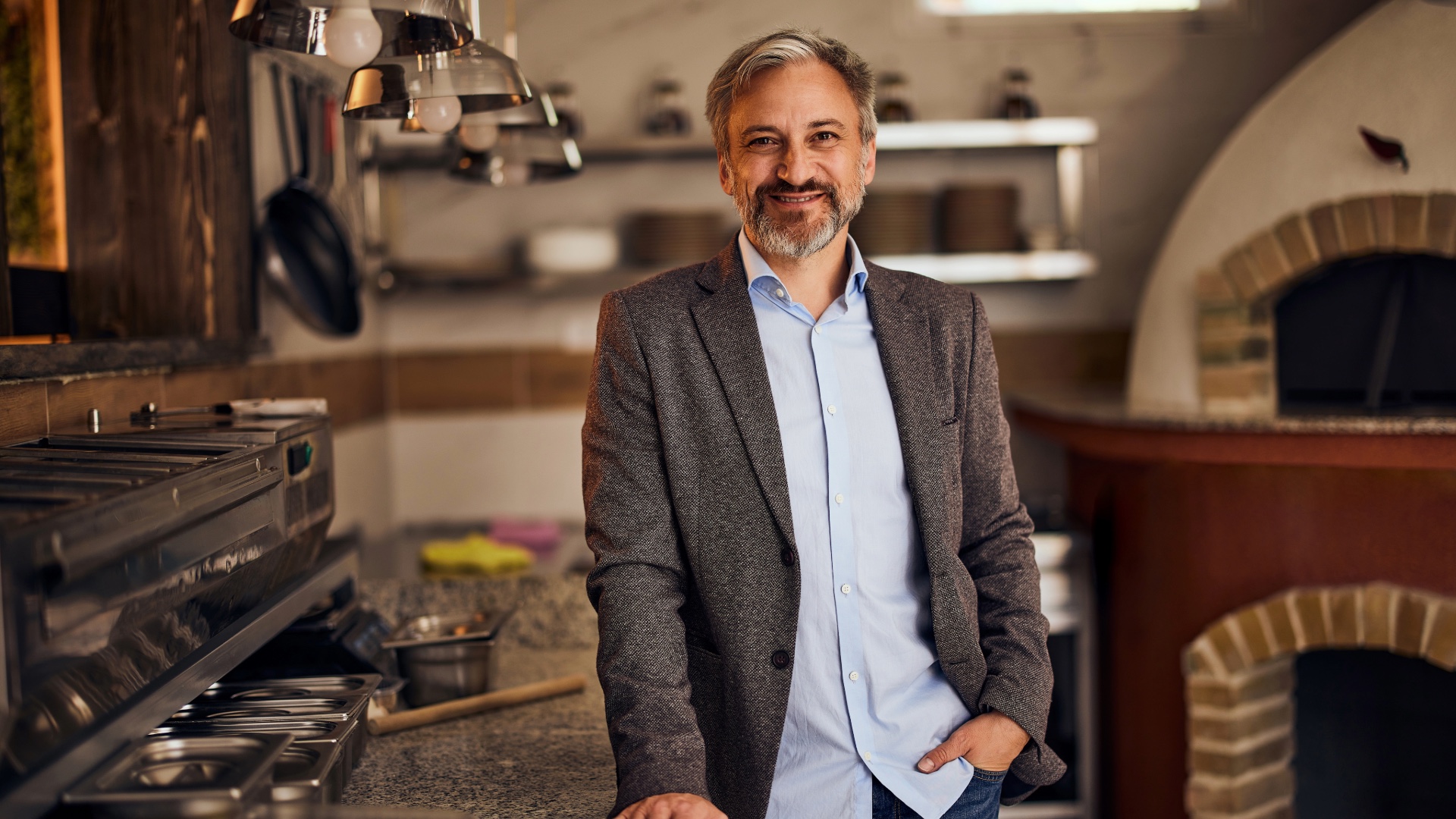 Restaurant owner standing in his commercial kitchen