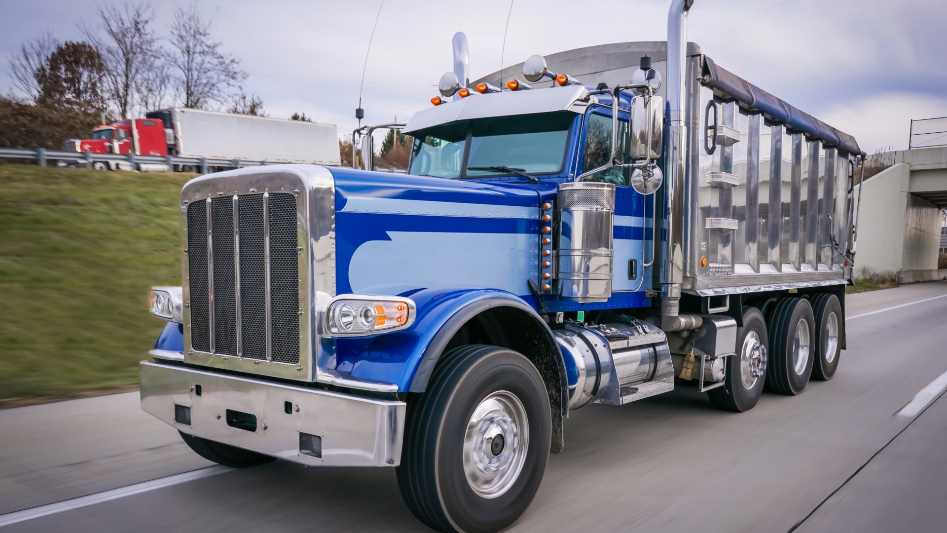 Blue dump truck traveling on a highway