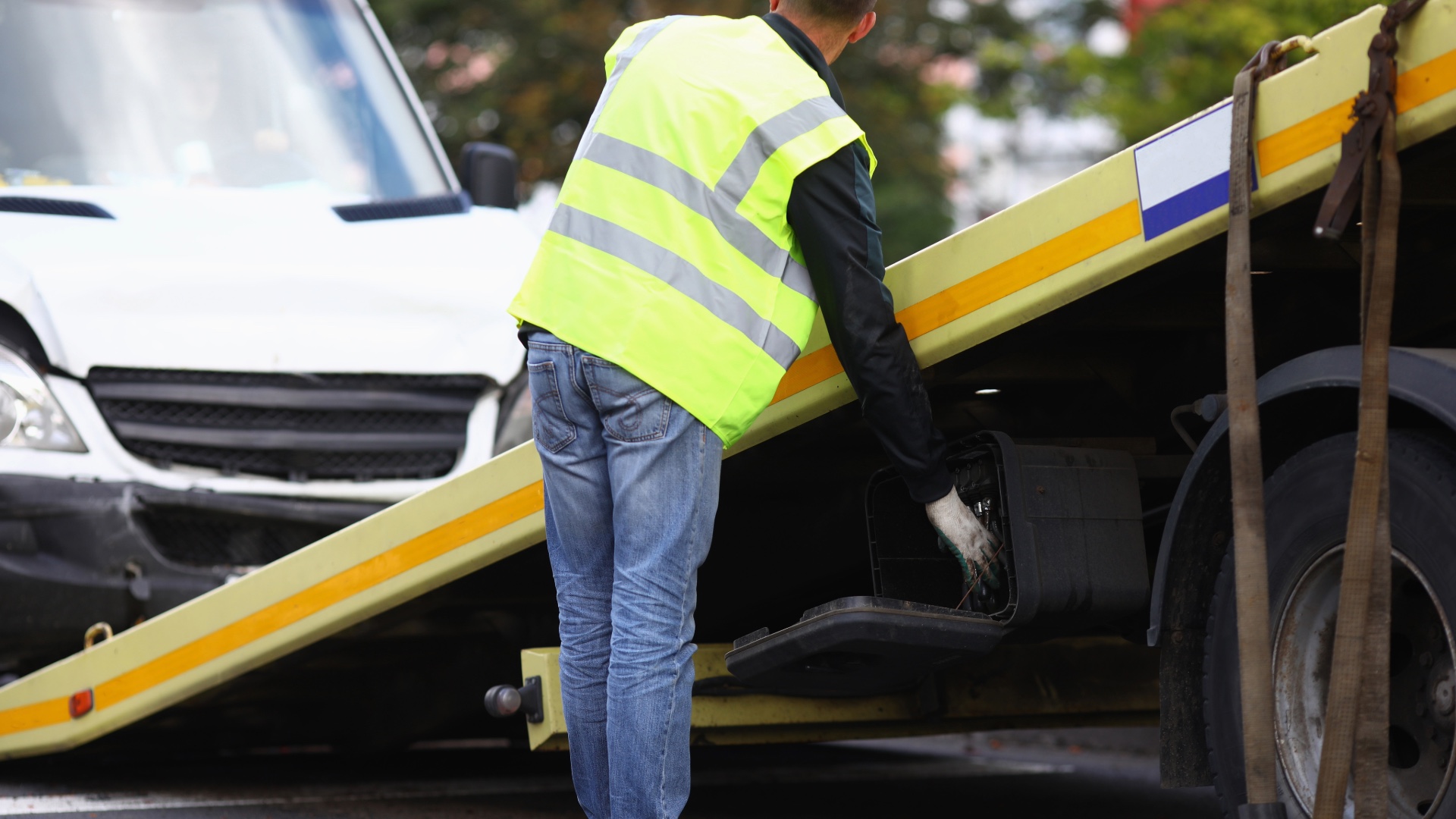 Tow truck operator securing a vehicle