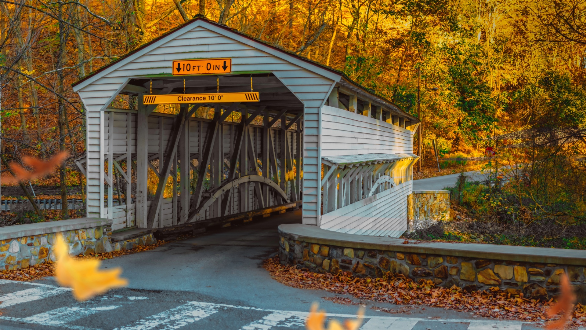 White covered bridge surrounded by autumn foliage in Chester Springs, Pennsylvania