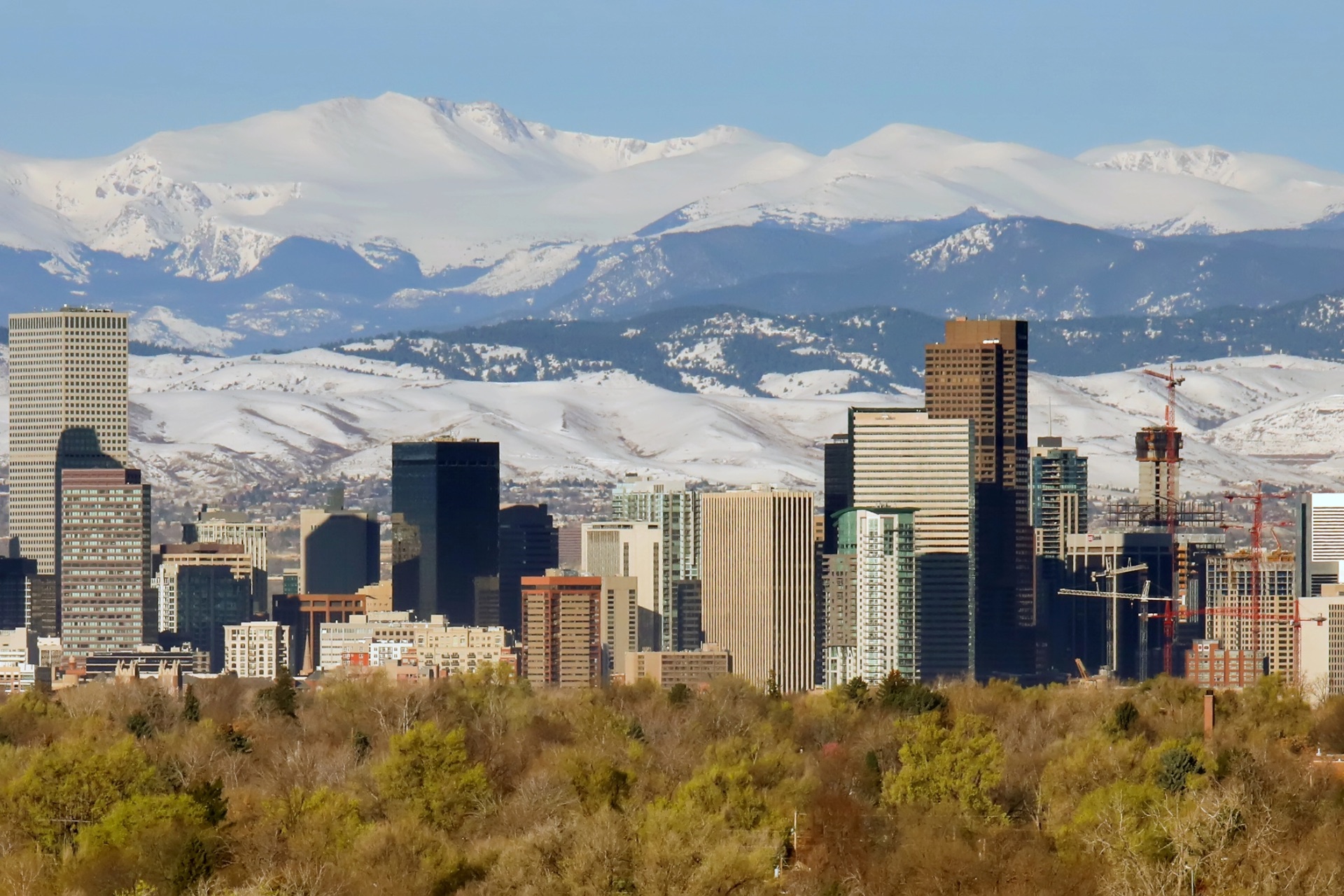 Denver skyline with snow-covered Rocky Mountains in the distance