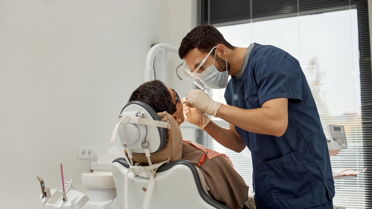 Dentist examining a patient during a dental visit