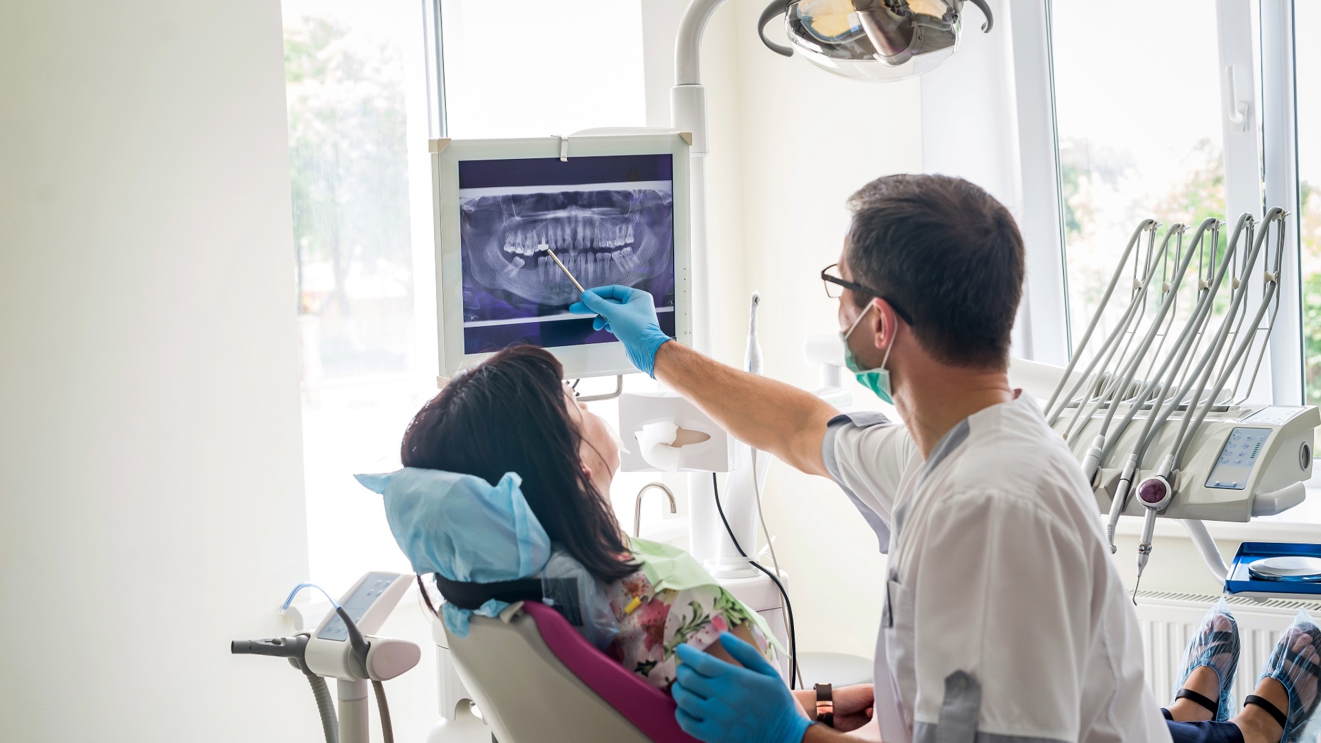 Dentist reviewing a dental X-ray with a patient