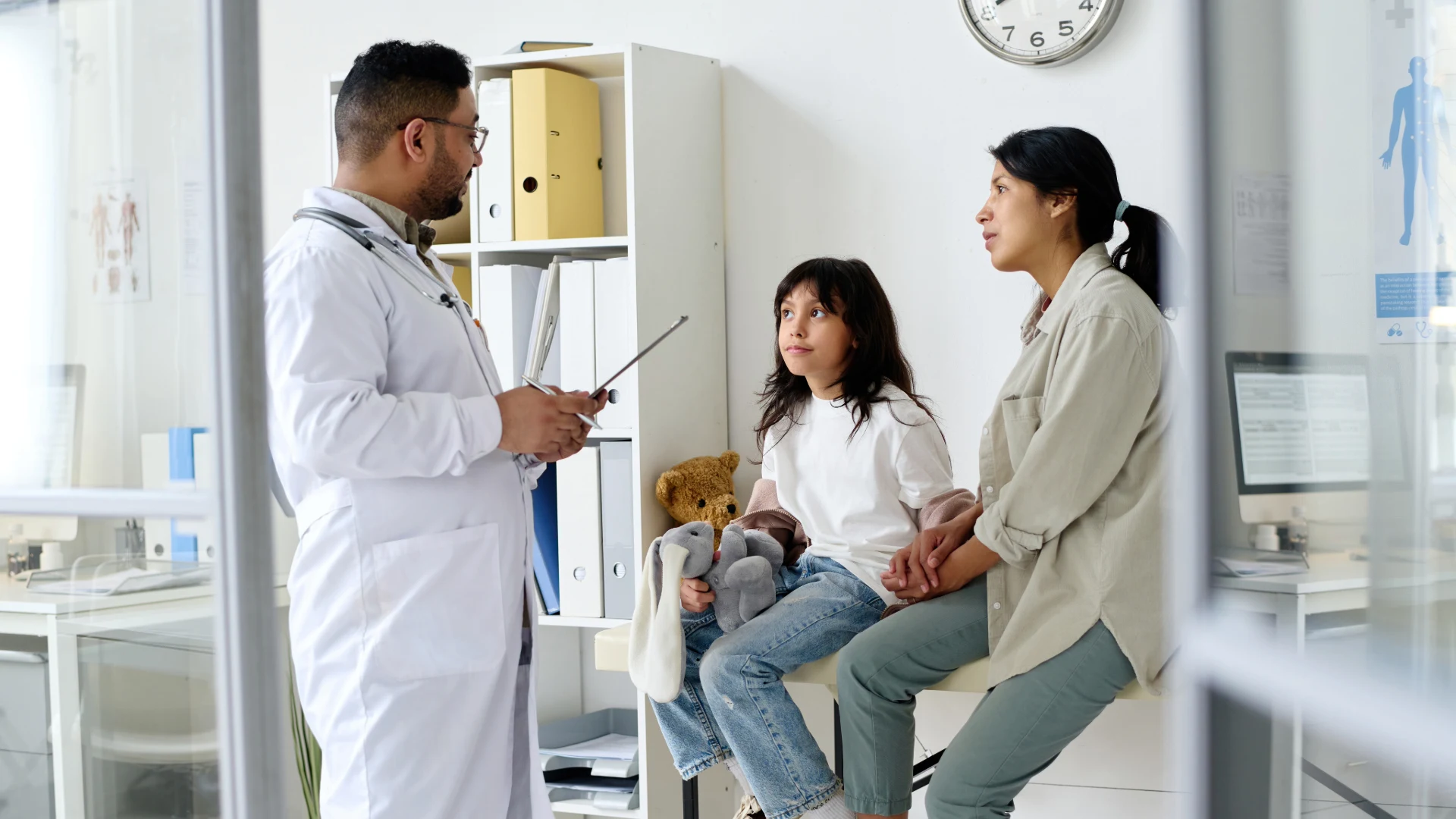Doctor speaking with a family in an exam room