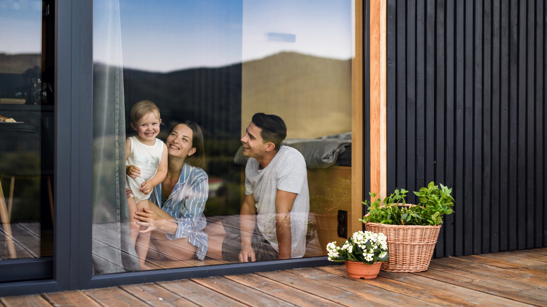 A family spending time together beside the window of their home