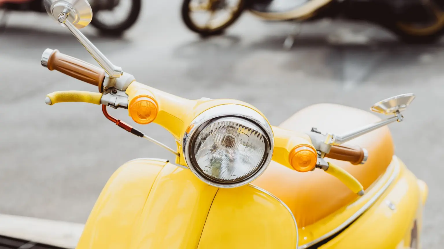 Yellow vintage-style scooter viewed from the front