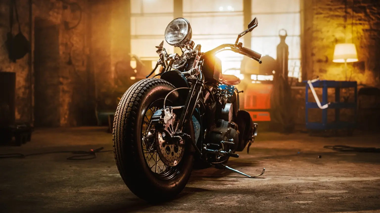 Custom classic motorcycle displayed in a warmly lit workshop