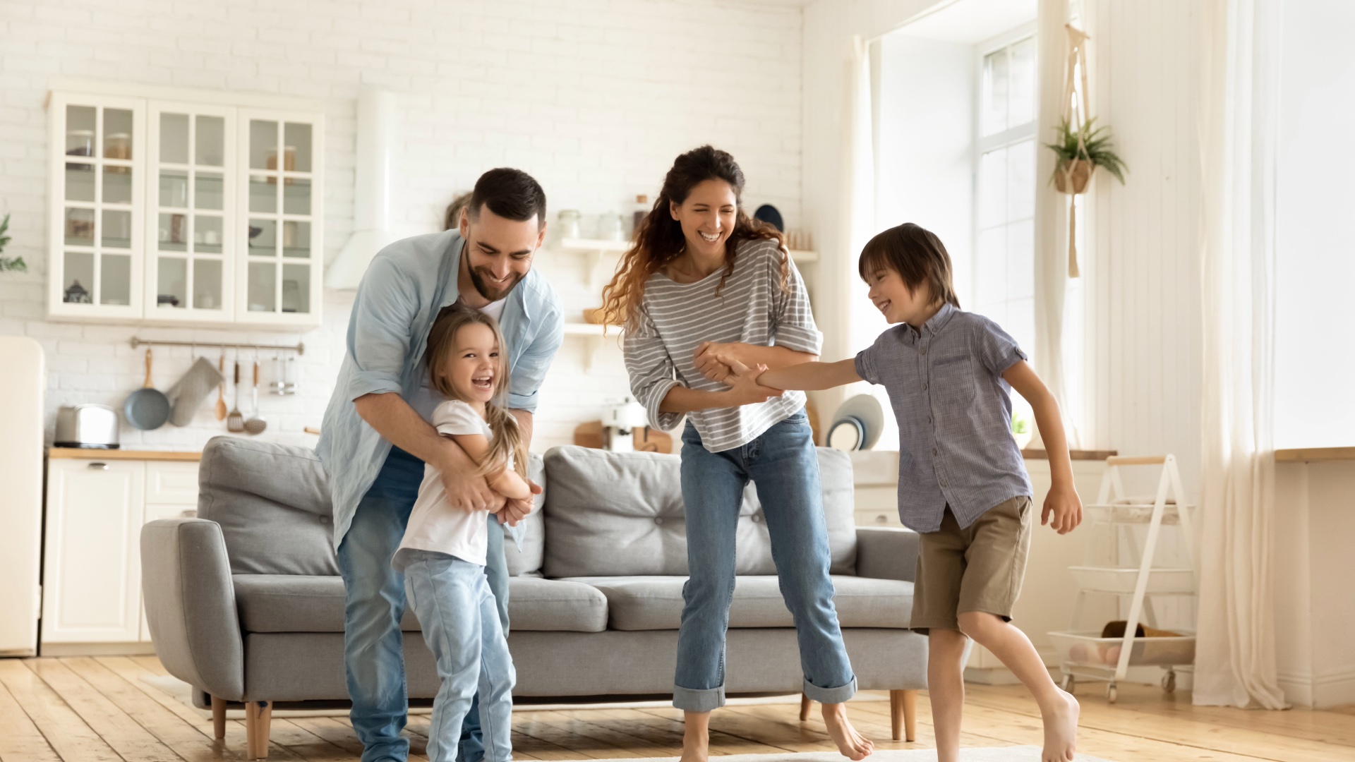 Family playing together in a bright apartment living room