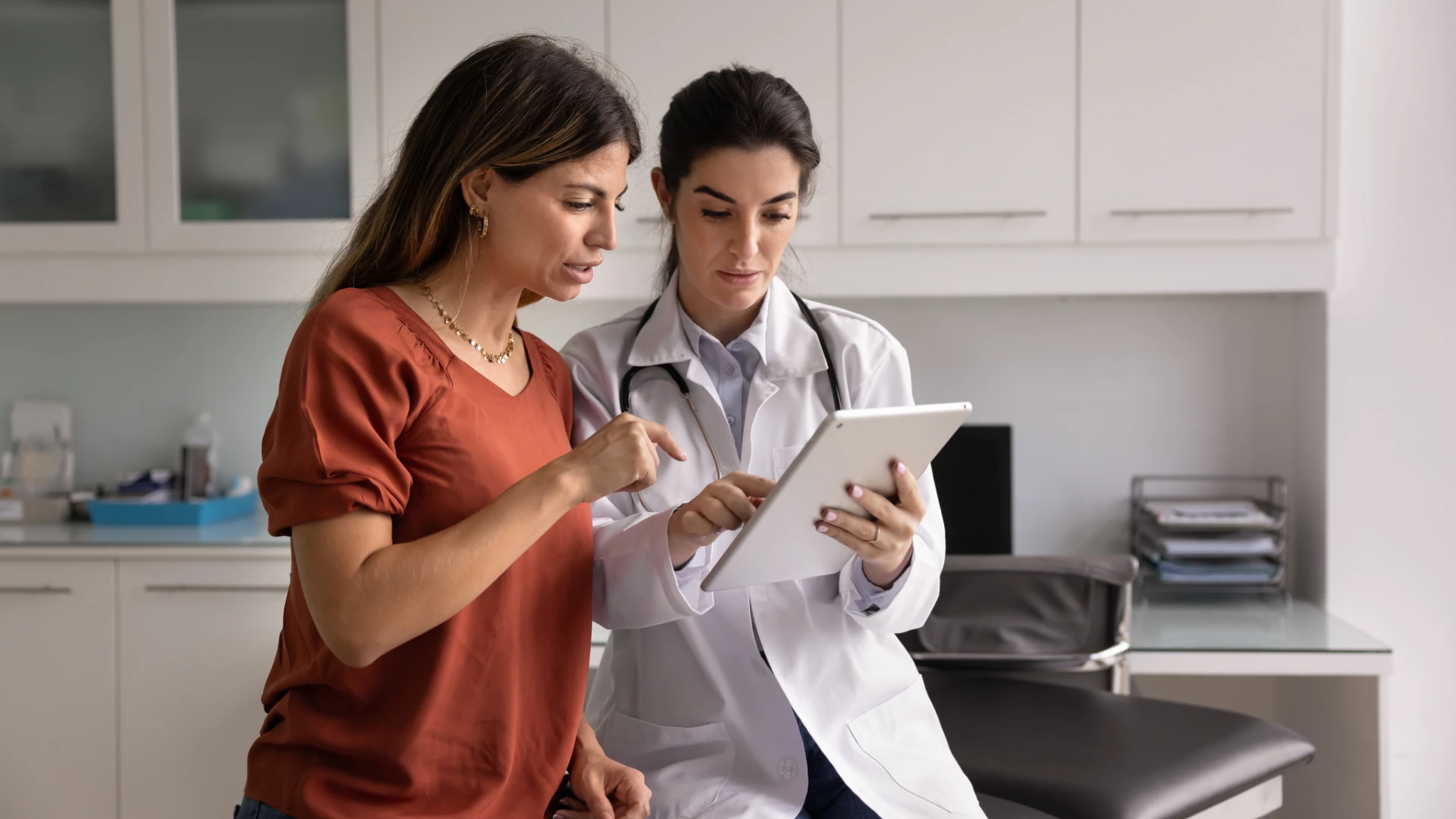 Doctor and patient reviewing information together on a tablet