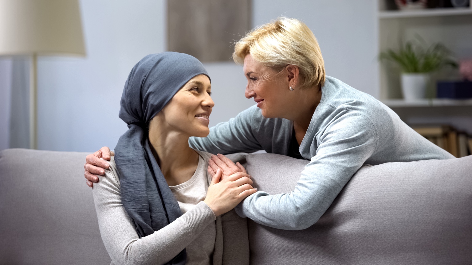 Woman in a headscarf receiving support from another woman