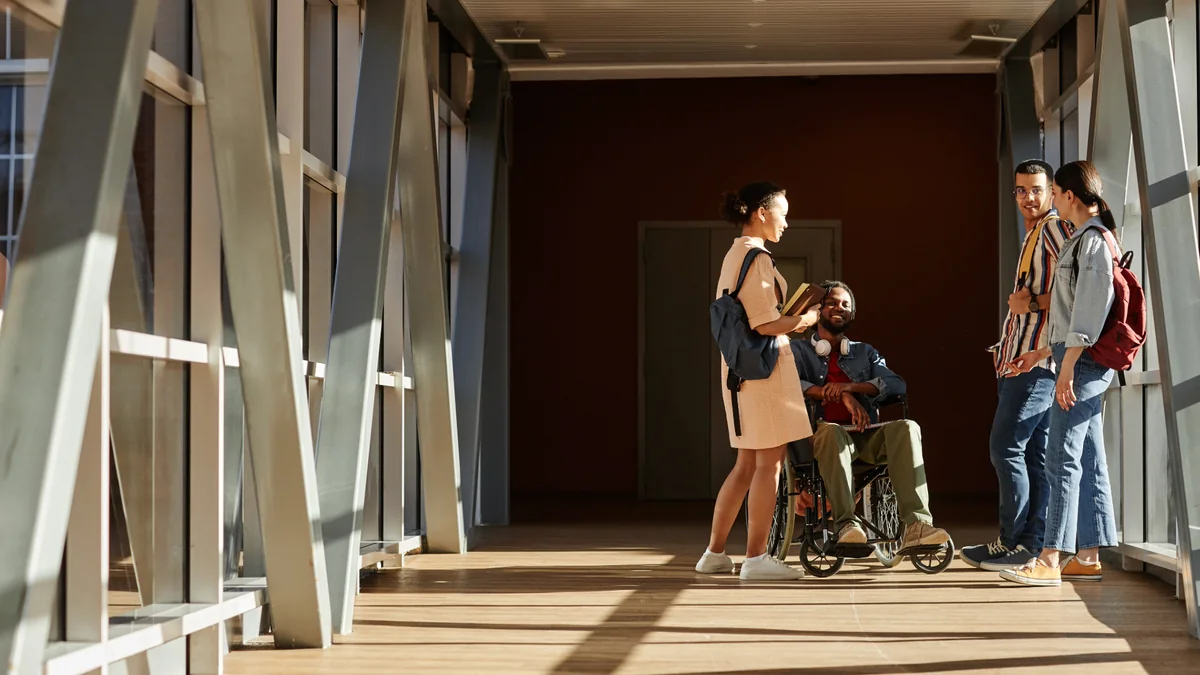Friends chatting together in a sunlit hallway