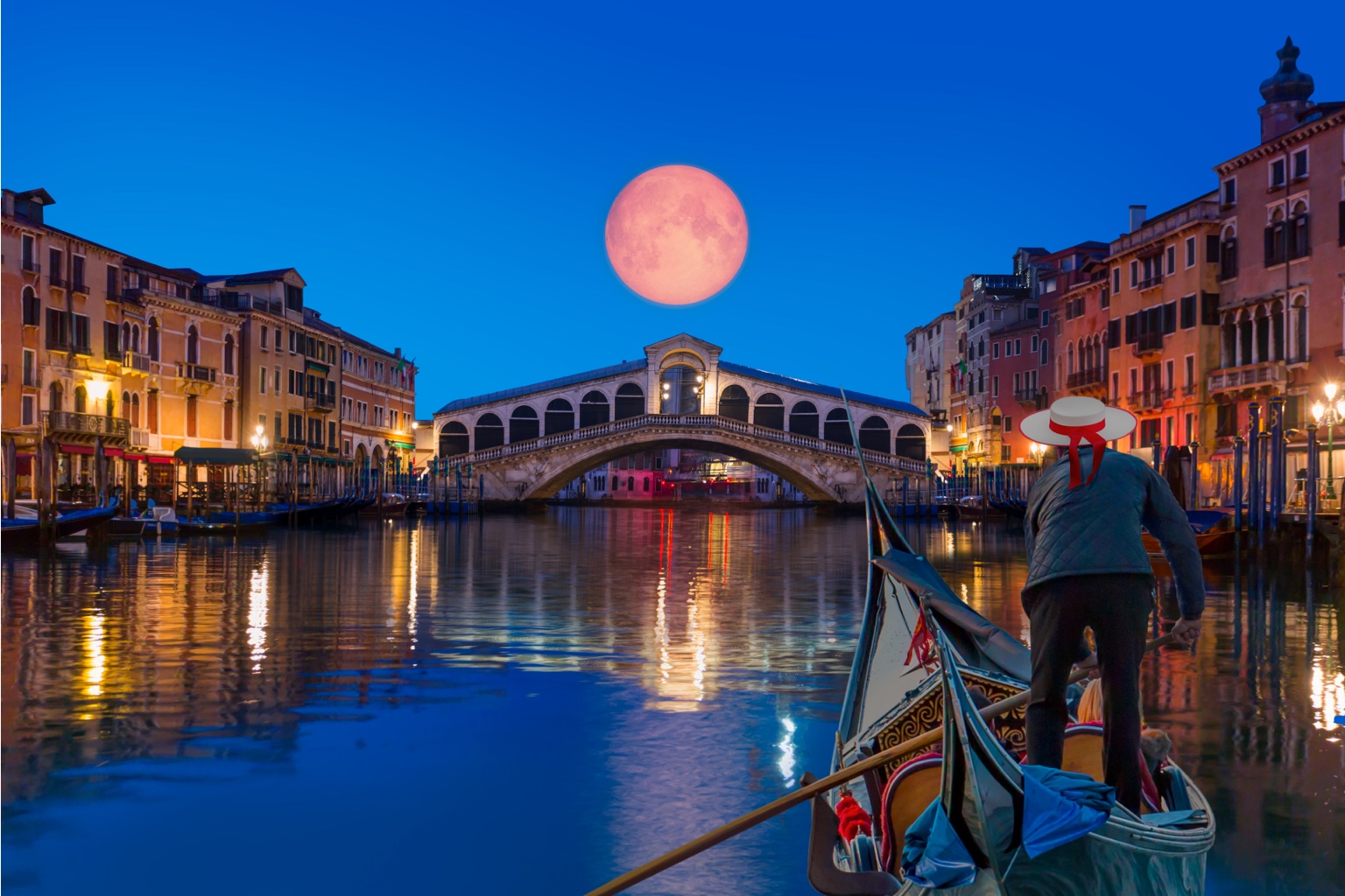 A gondolier approaching the Rialto Bridge beneath a full moon in Venice