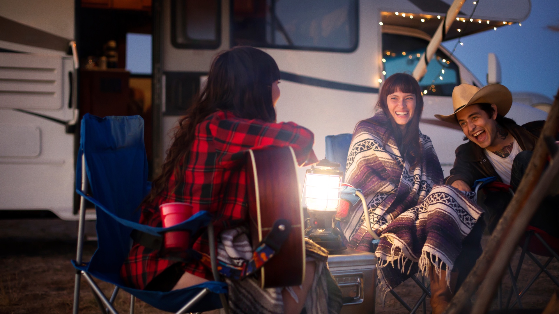 Friends enjoying an evening beside their RV
