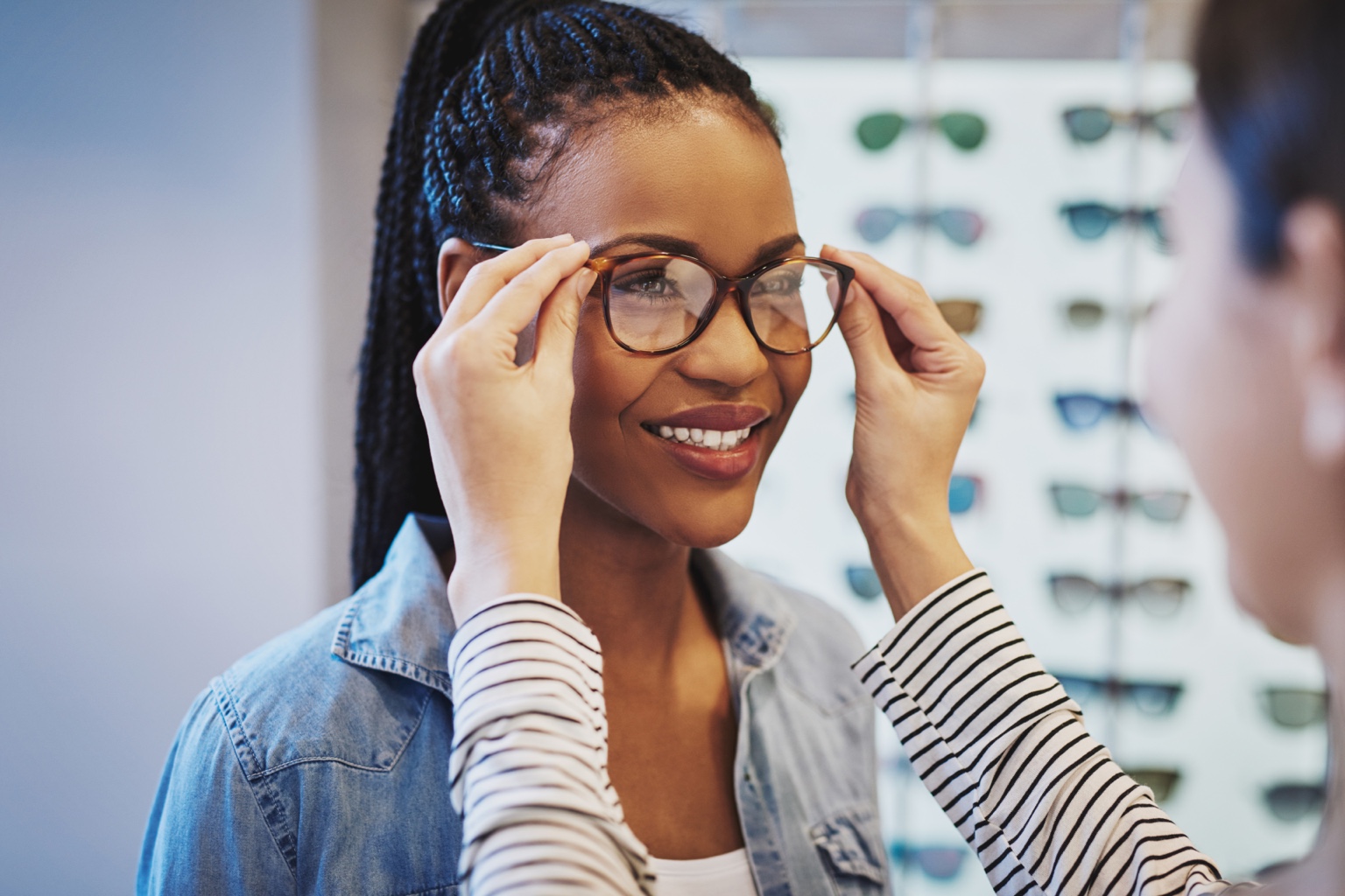 Woman trying on eyeglasses at an optical shop